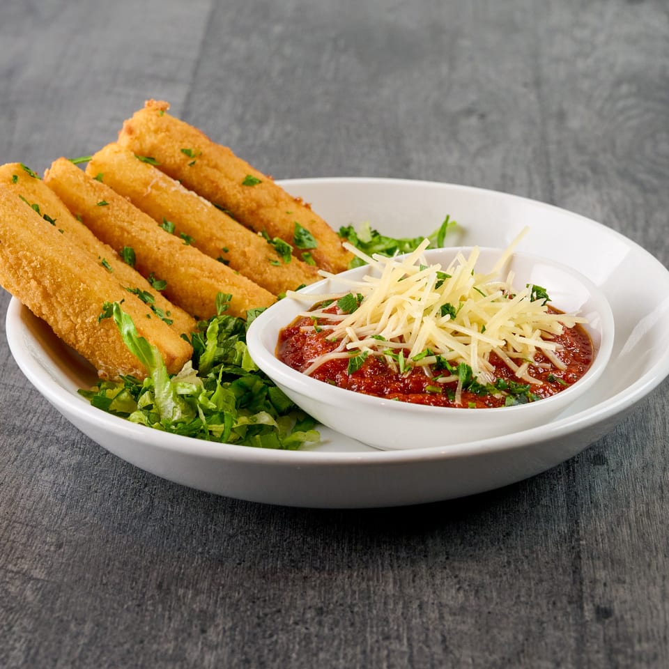Four golden-brown mozzarella sticks with a side of marinara sauce topped with shredded cheese and parsley.